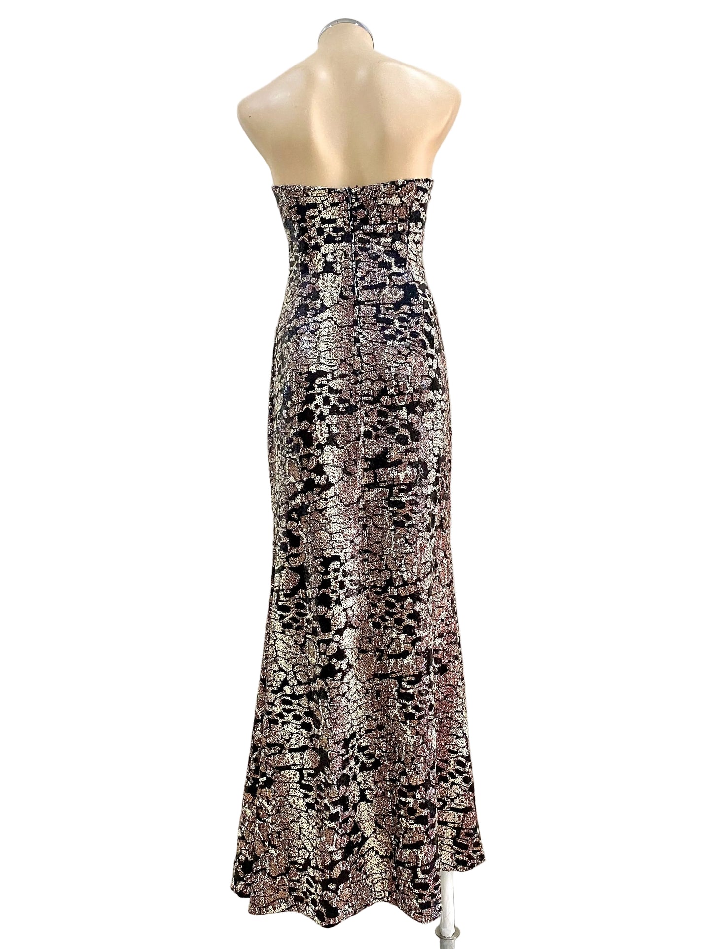 Mannequin wearing a strapless, patterned dress against a plain background