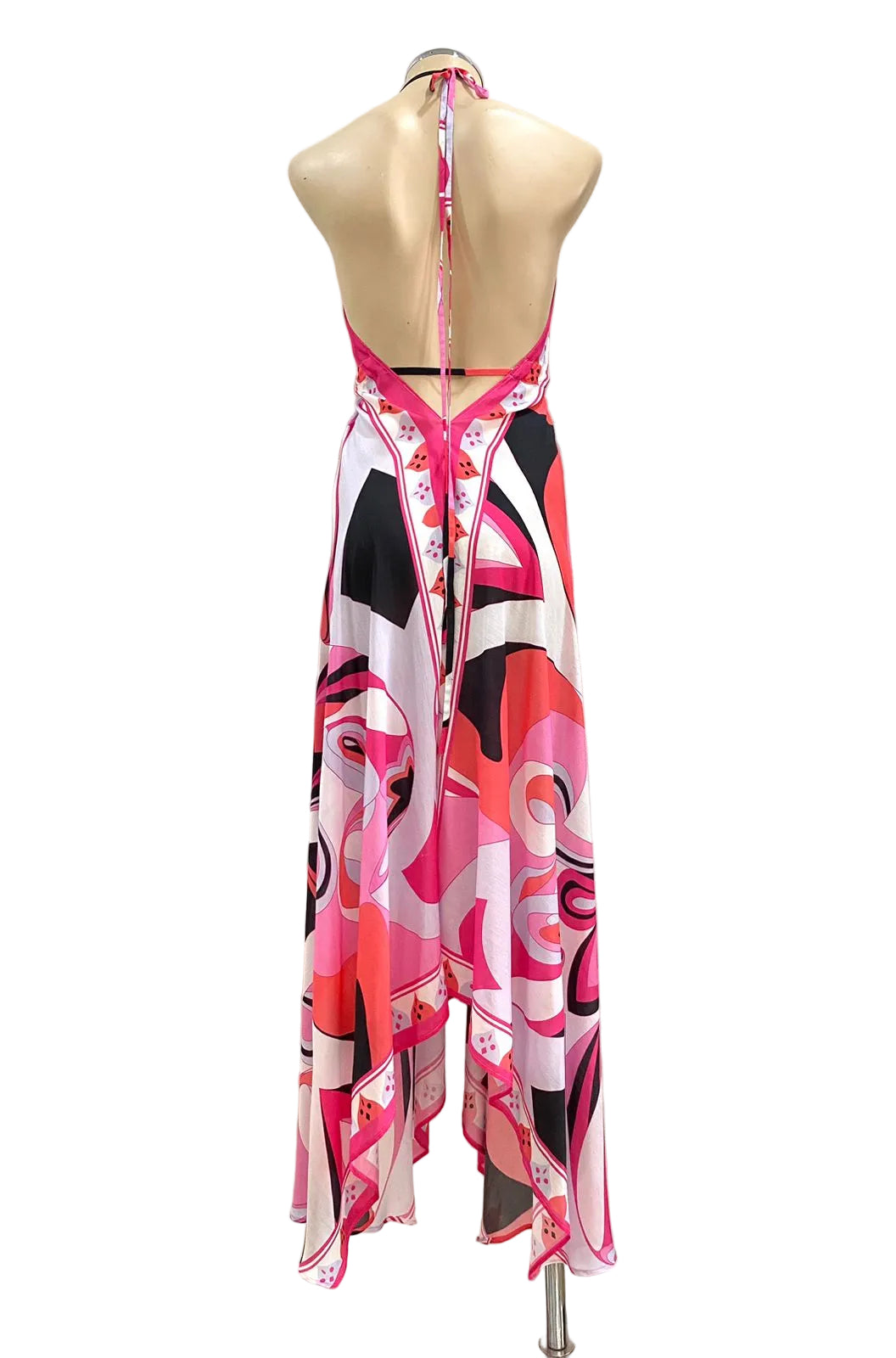 Mannequin wearing a colorful dress with abstract patterns against a plain background