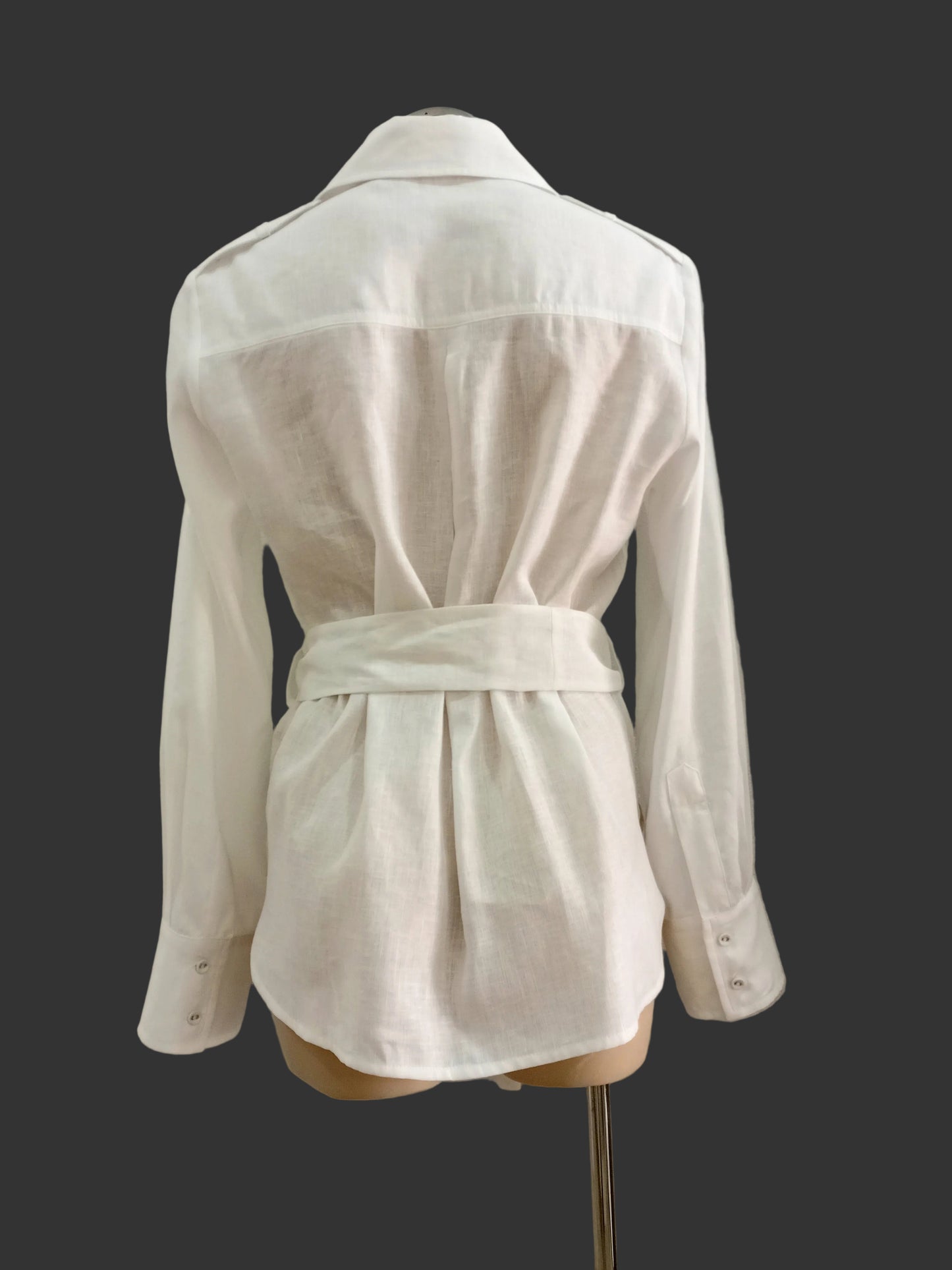 White linen shirt on a mannequin against a plain background