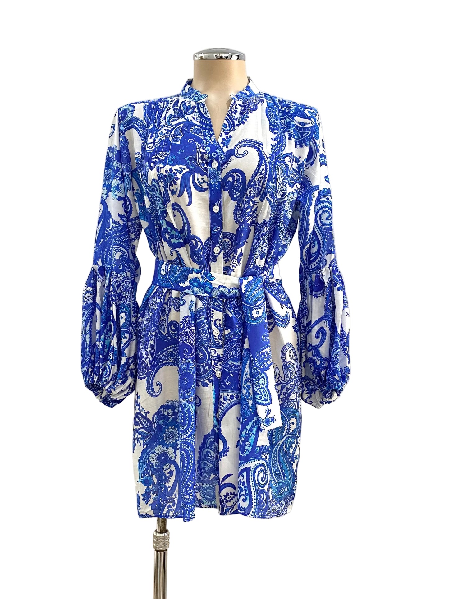 Blue and white patterned dress on a mannequin against a white wall.