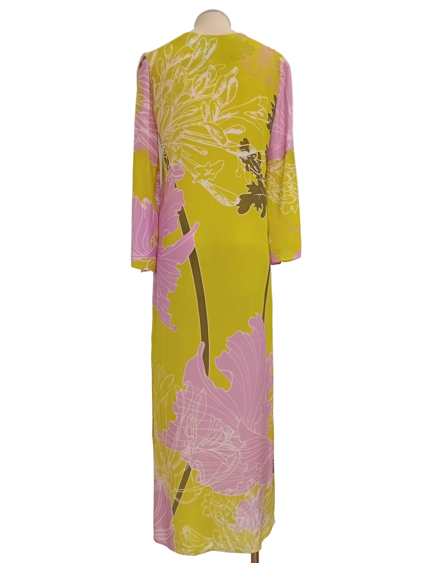 Monet Tunic Dress in lime and pink floral against a white wall.