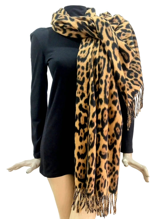 Leopard print scarf draped over a black top on a mannequin against a white background