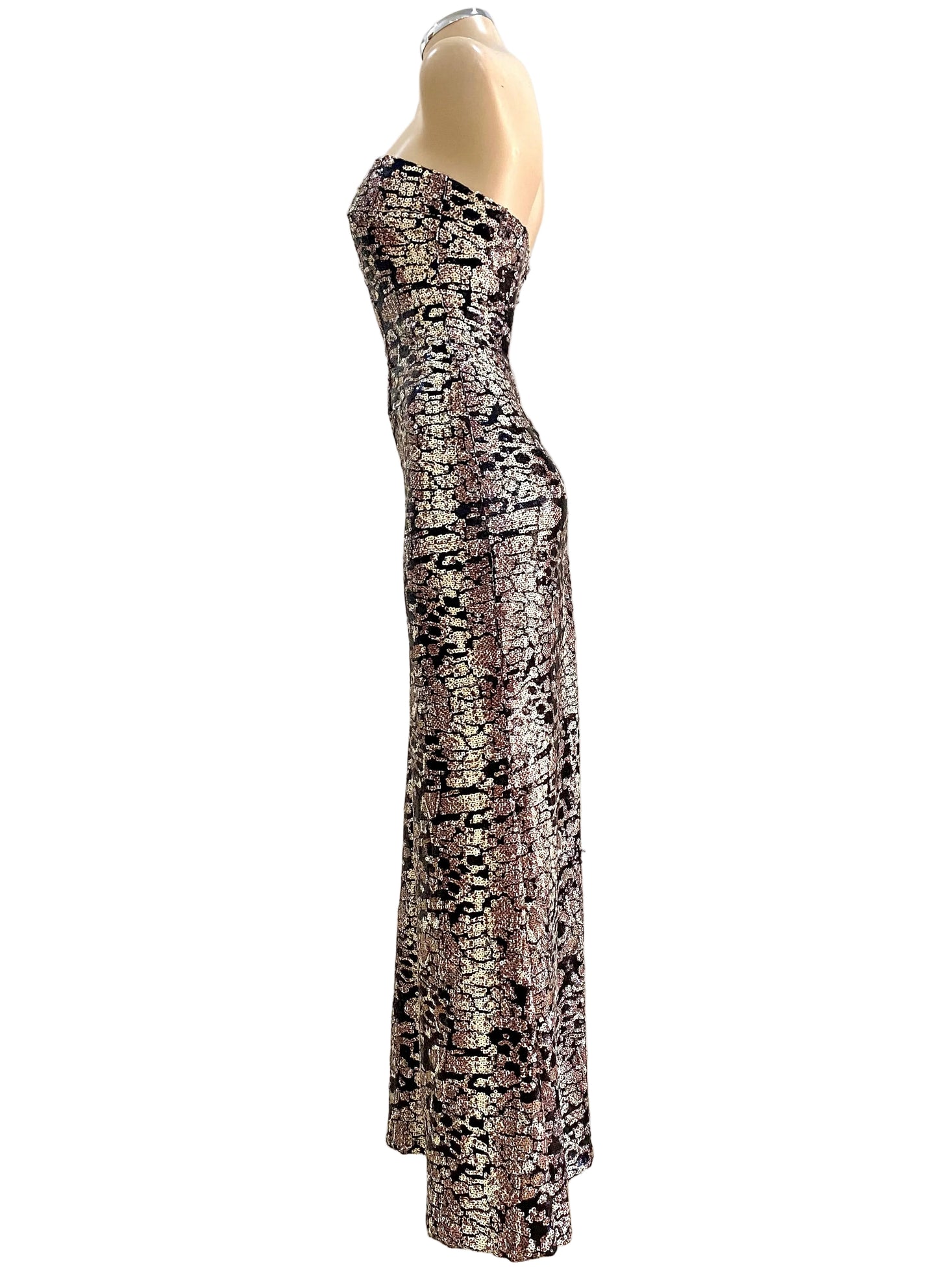 Strapless snake patterned dress on a mannequin against a white wall.
