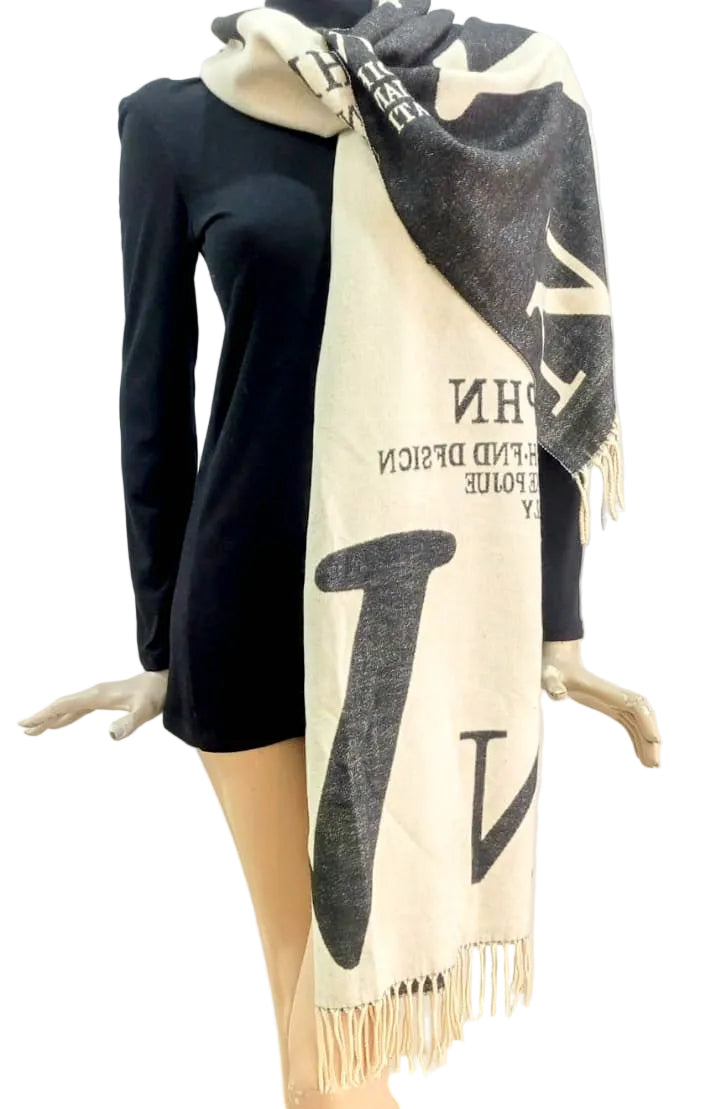 Mannequin wearing a black and white scarf with visible branding on a plain background