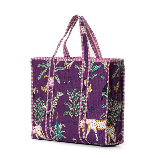 Purple tote bag with animal and plant pattern on a purple background