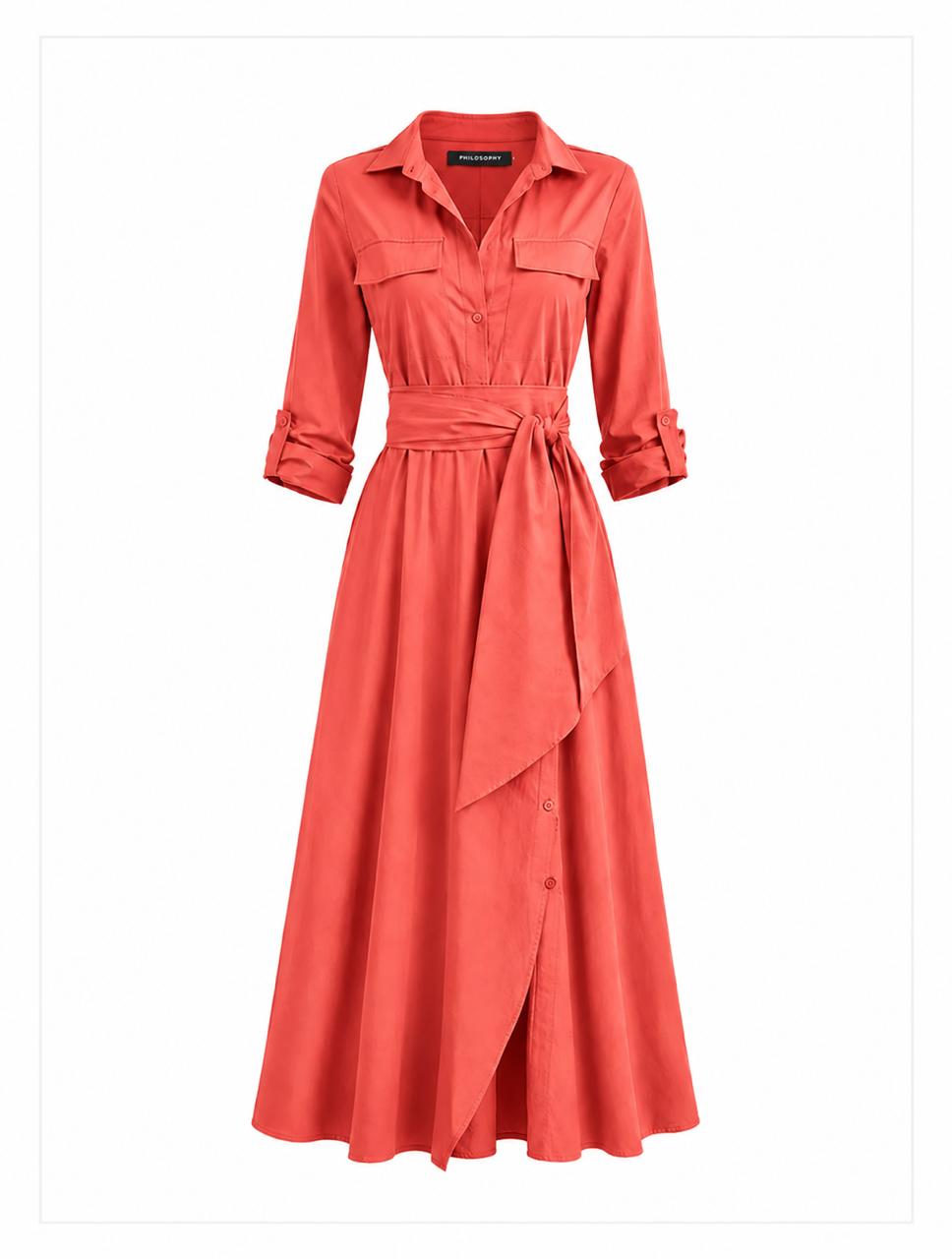 Salmon shirt dress with a large belt on a plain background