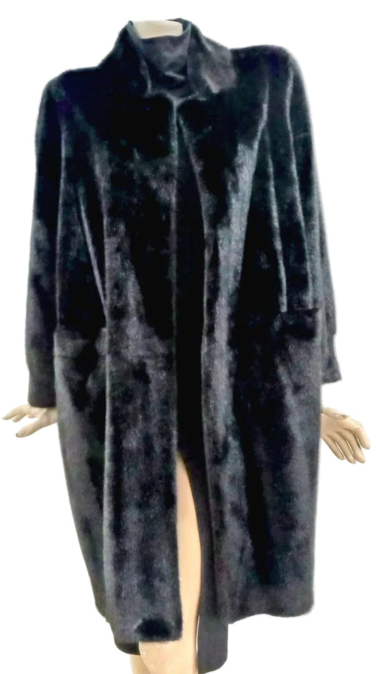 Black fur coat on a mannequin against a plain background