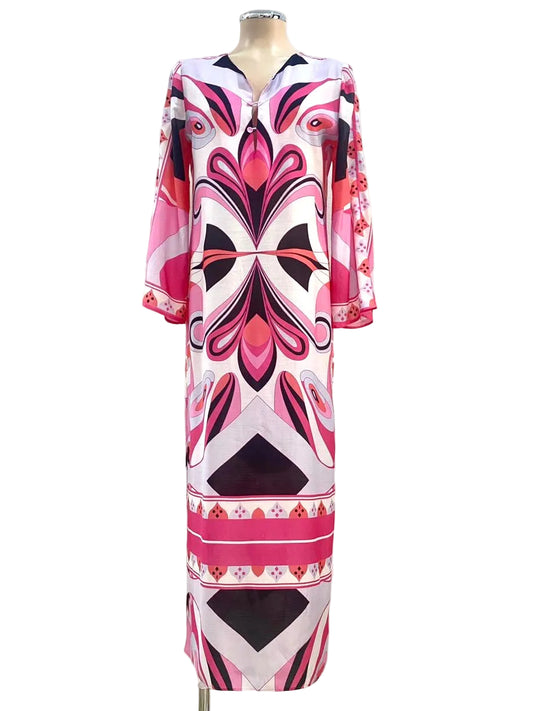 Mannequin wearing a patterned dress with pink, black, and white design against a plain background