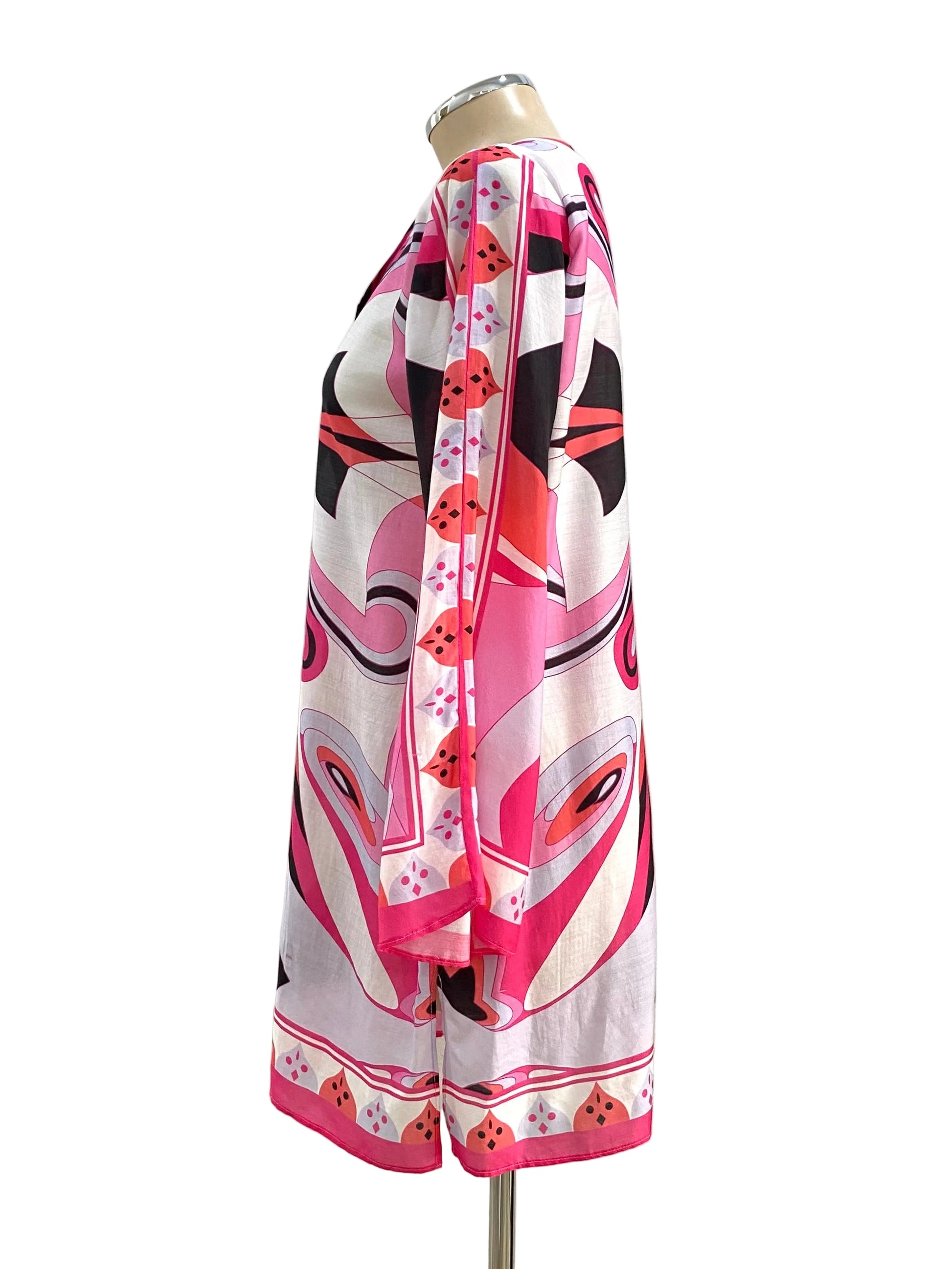 Mannequin wearing a colorful patterned dress against a white background