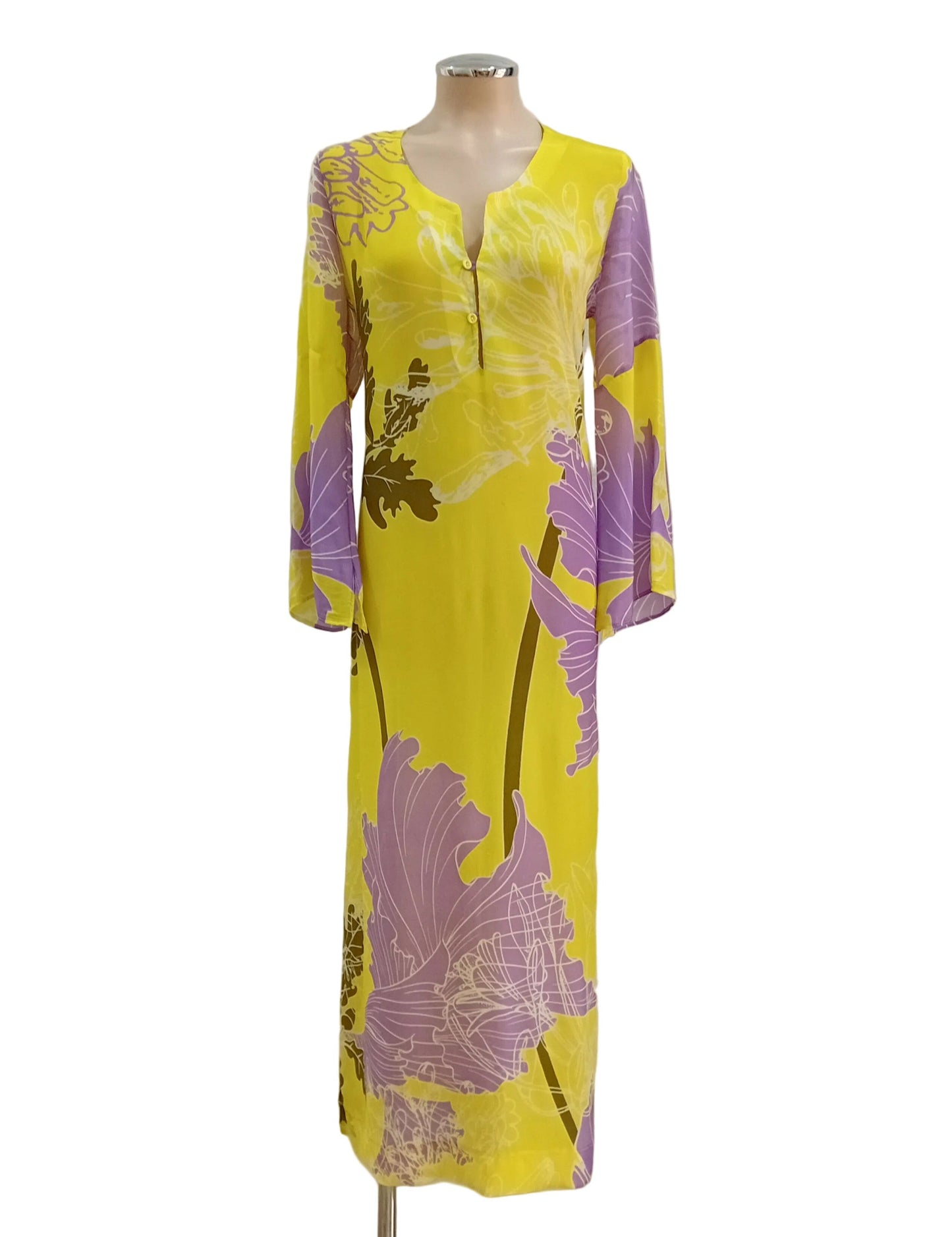 Yellow dress with purple floral pattern on a mannequin against a white wall.