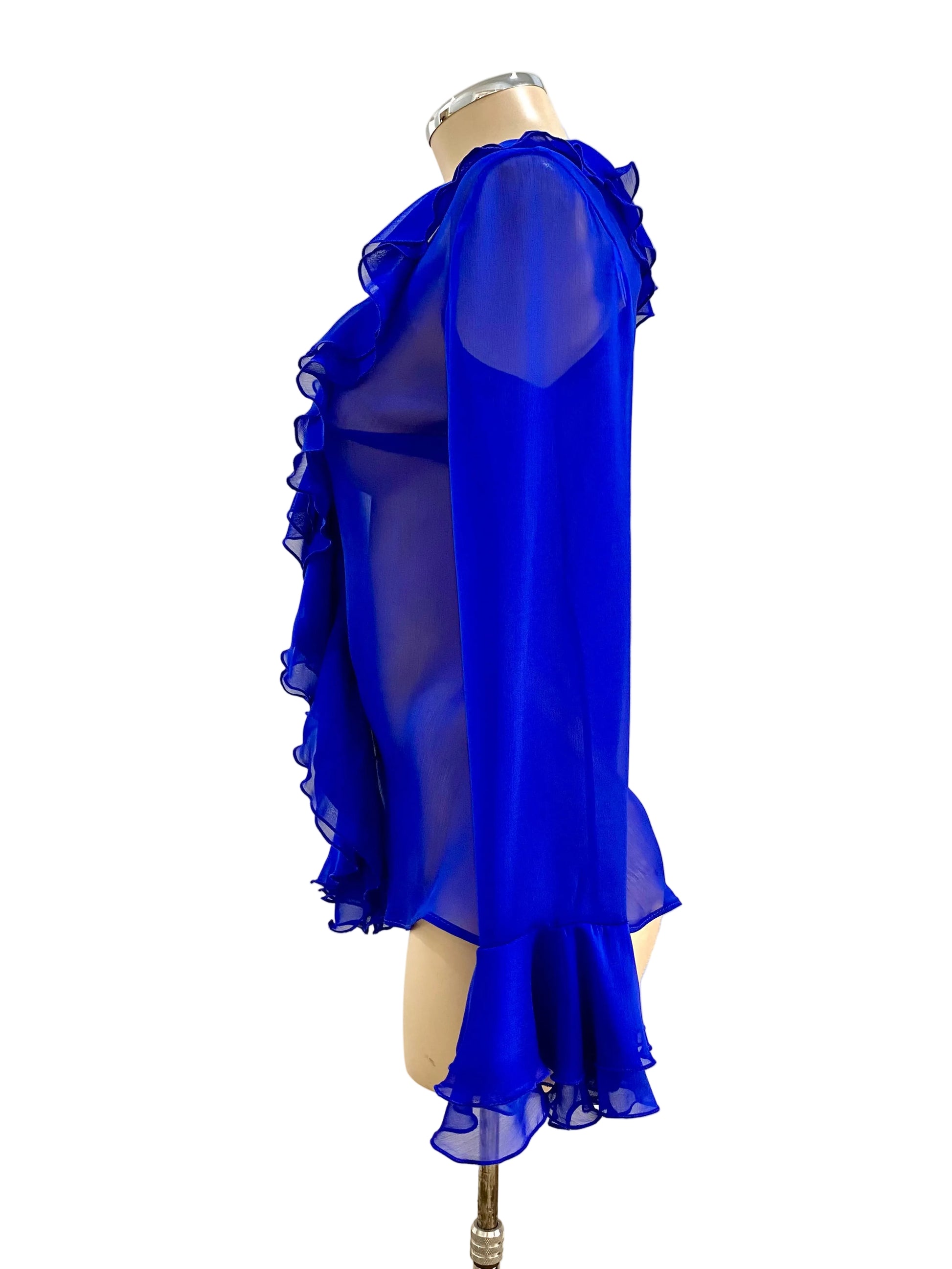 Blue ruffled blouse on a mannequin against a white wall