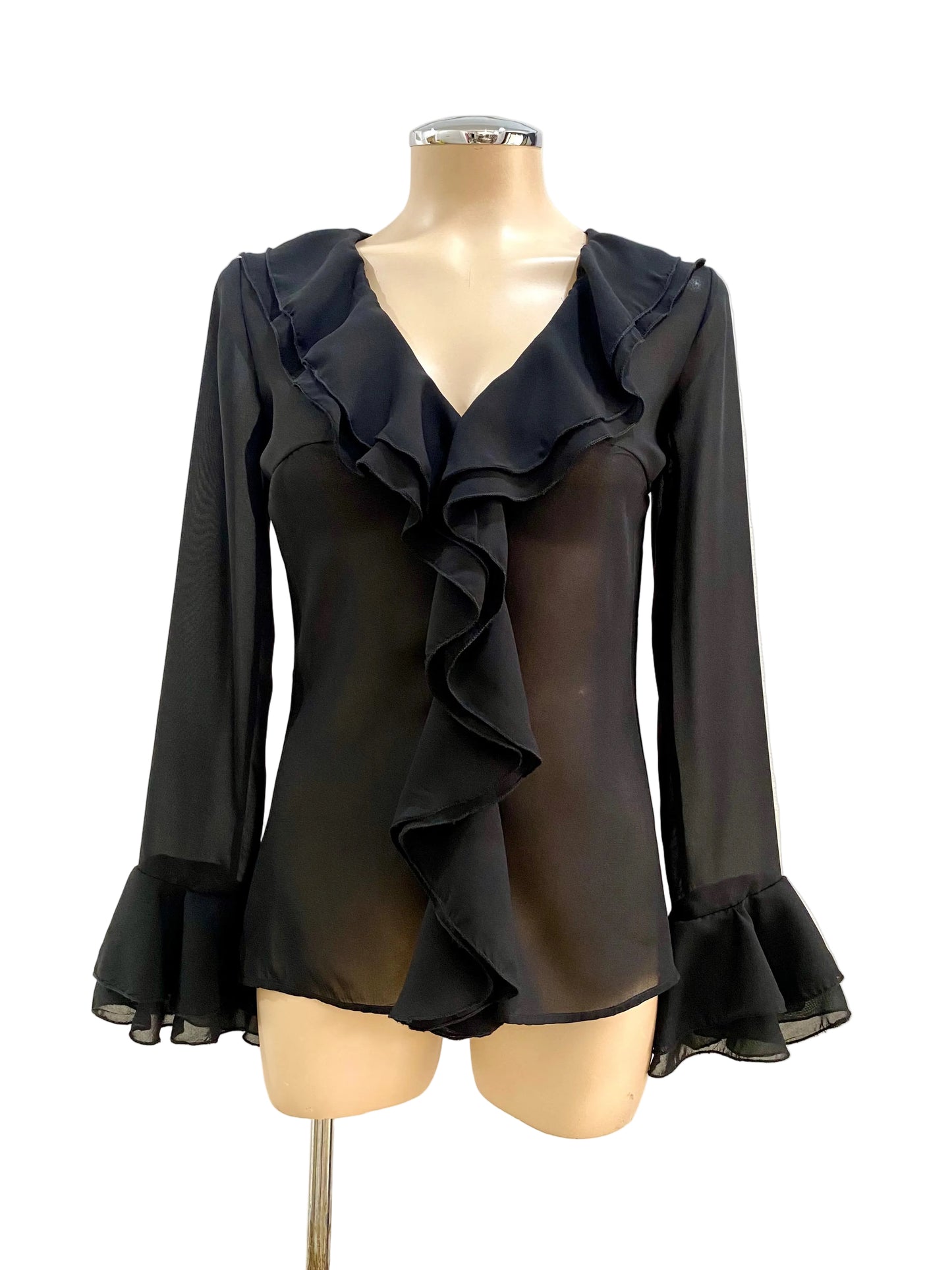 Black ruffled blouse on a mannequin against a white background