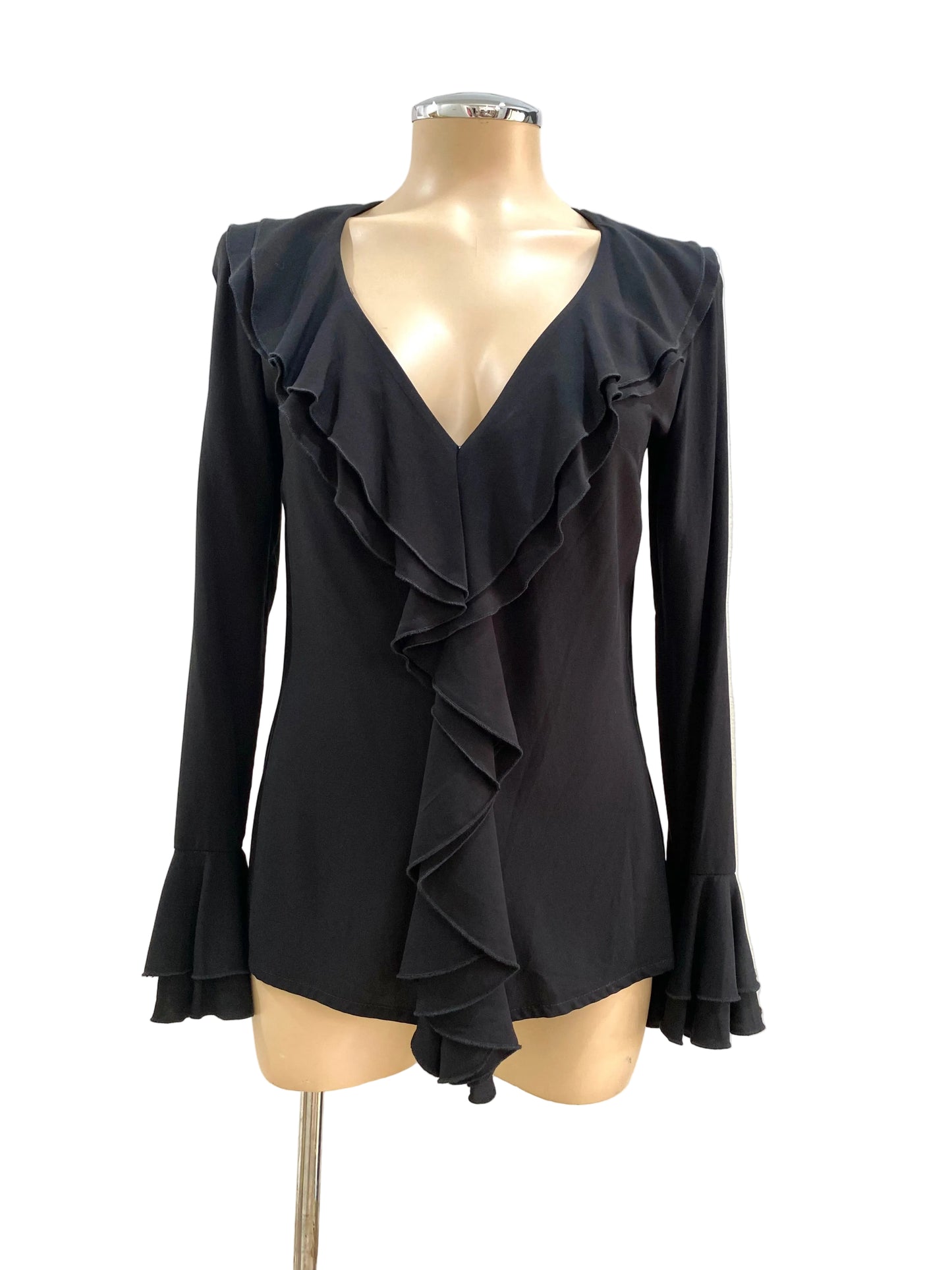 Black ruffled blouse on a mannequin against a plain background