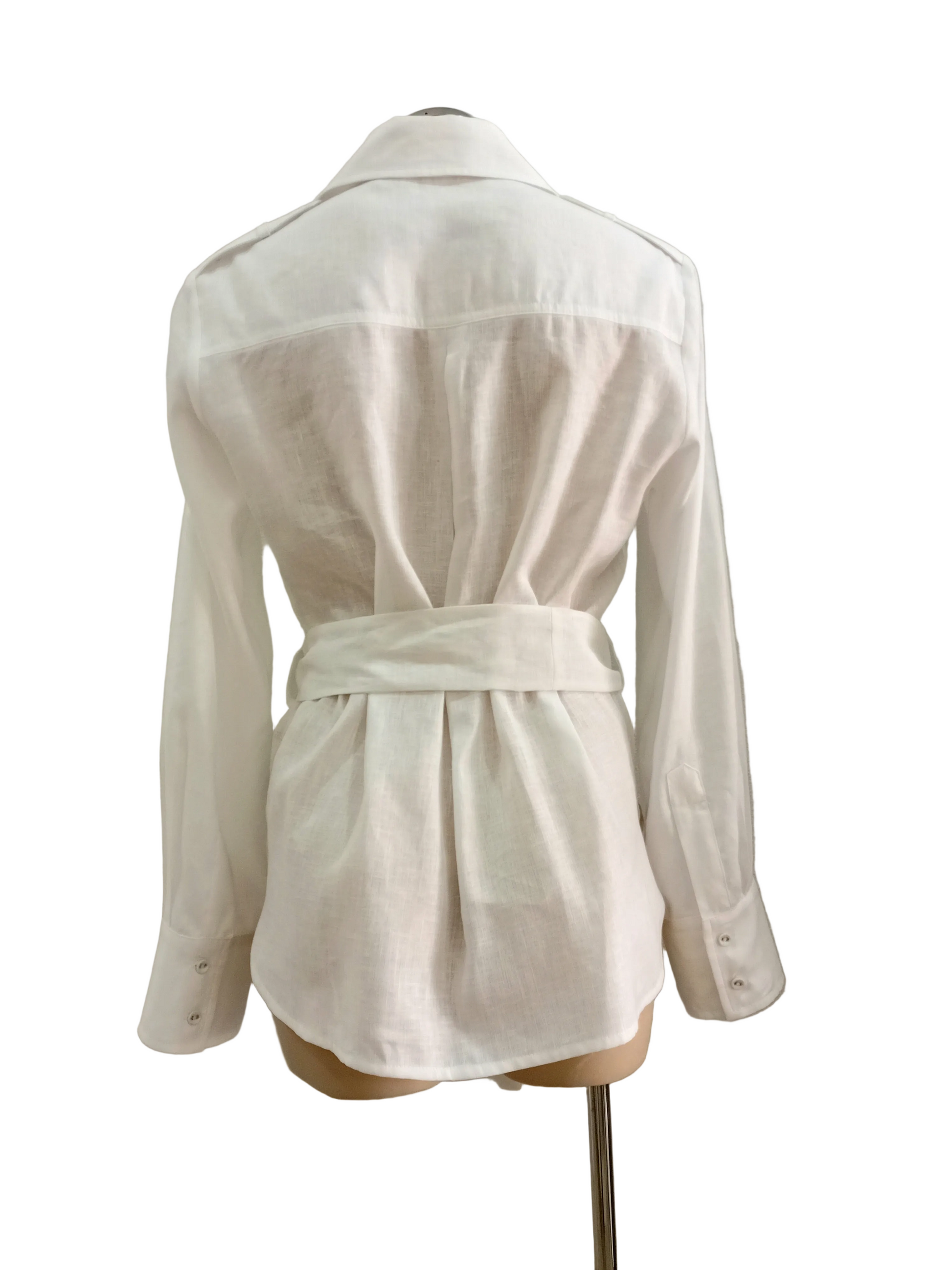 White linen shirt on a mannequin against a plain background