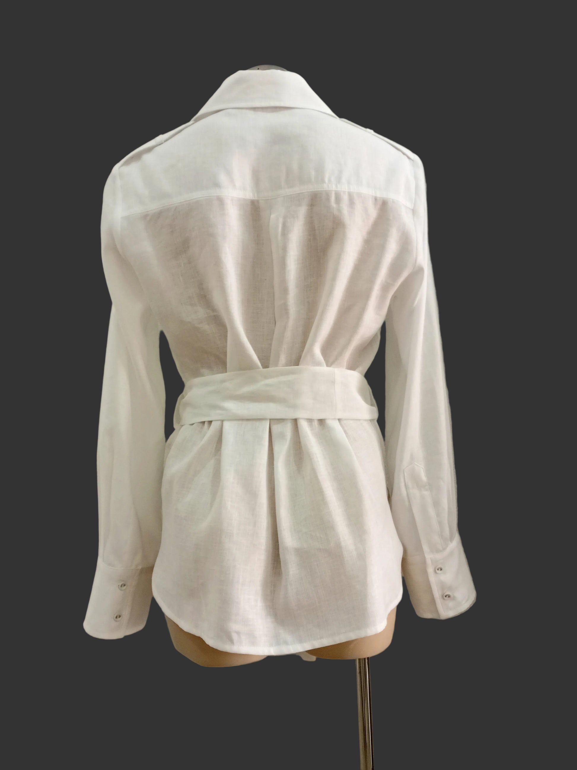 White linen shirt on a mannequin against a plain background