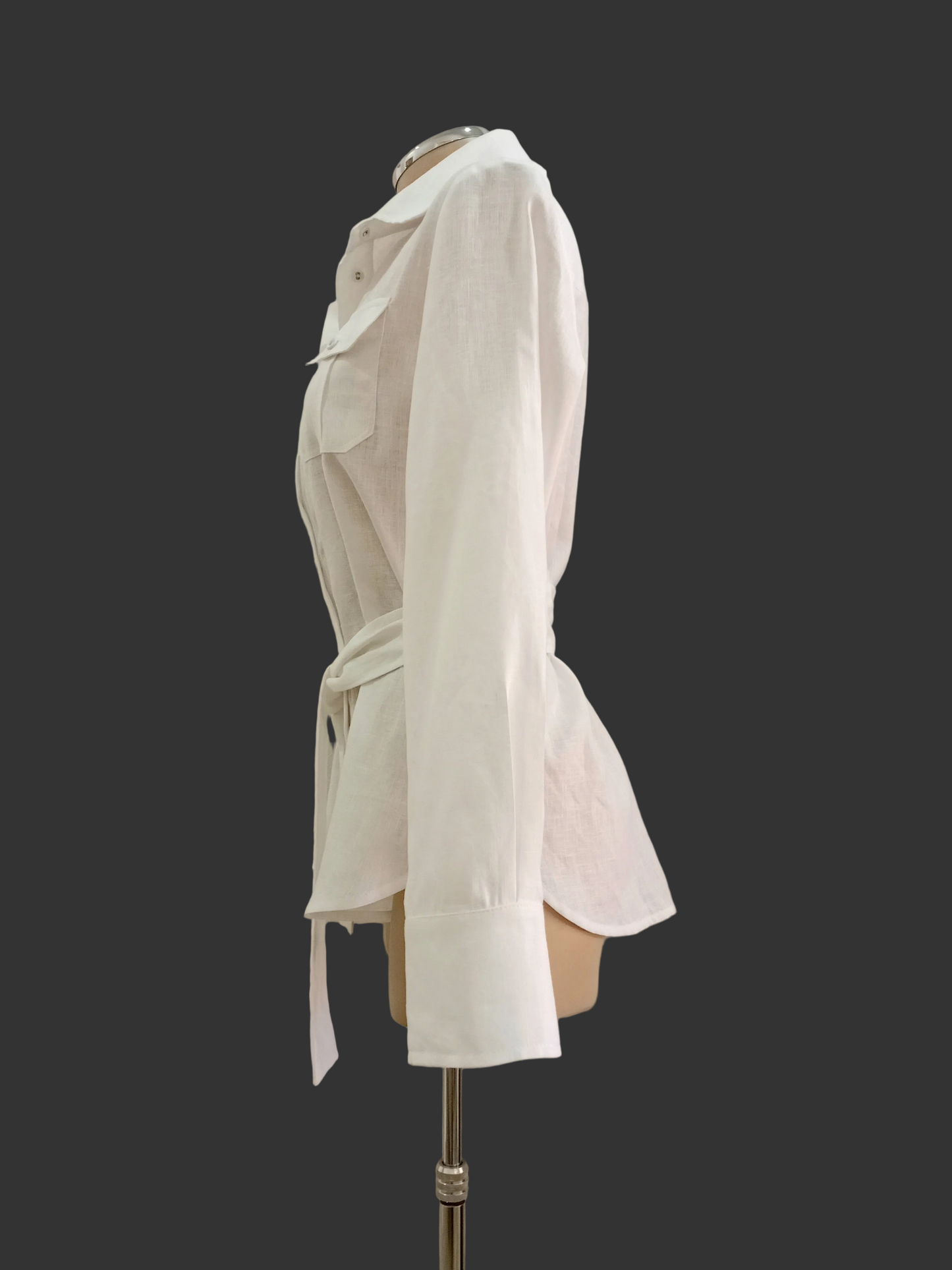 White linen shirt on a mannequin against a plain background