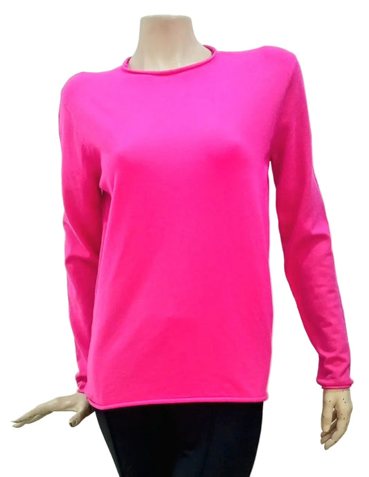 Classic funnel neck knit in bright pink with long-sleeve and black pants on a white background