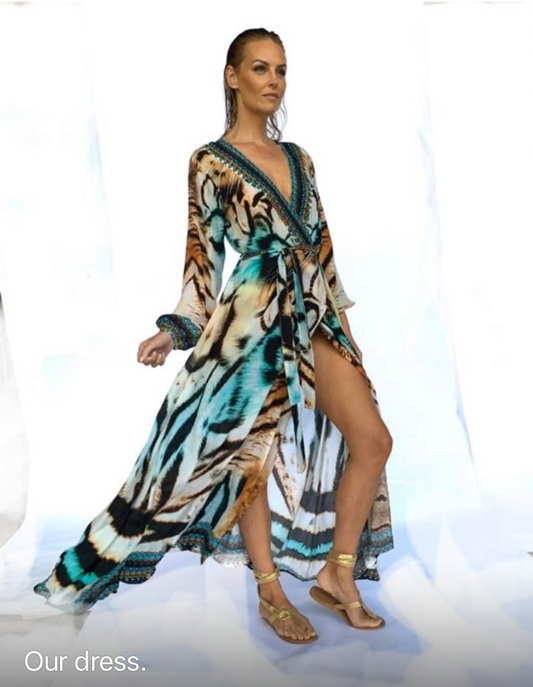 Woman wearing a tiger print dress with a slit on a white background