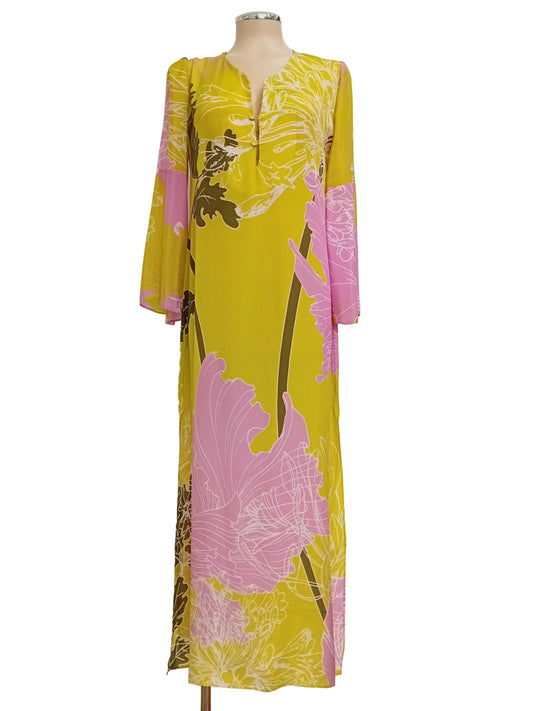 Monet tunic dress with lime and pink floral pattern on a mannequin against a neutral wall.