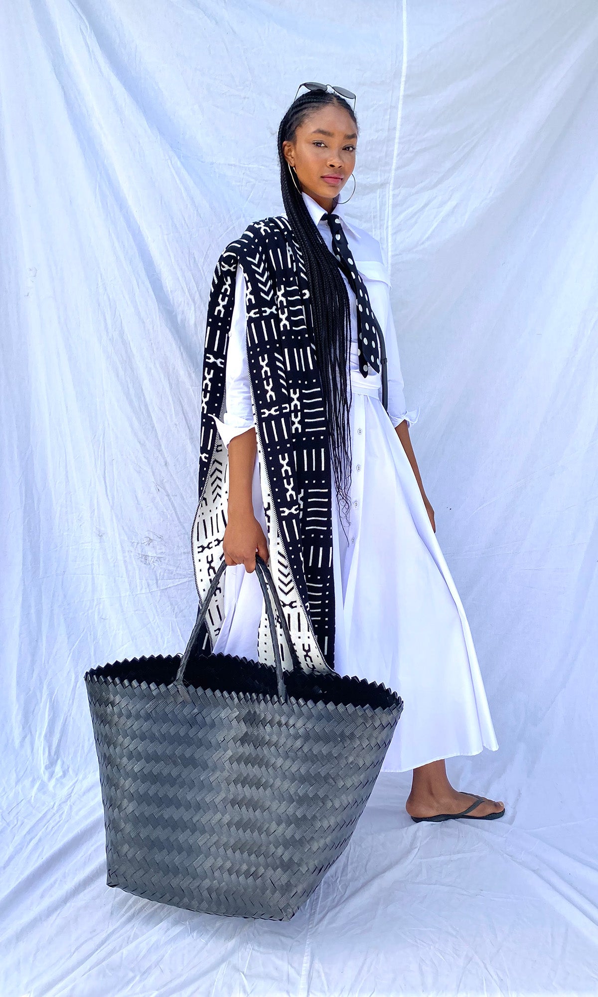 White shirtwaister dress on model with white fabric background and black accessories